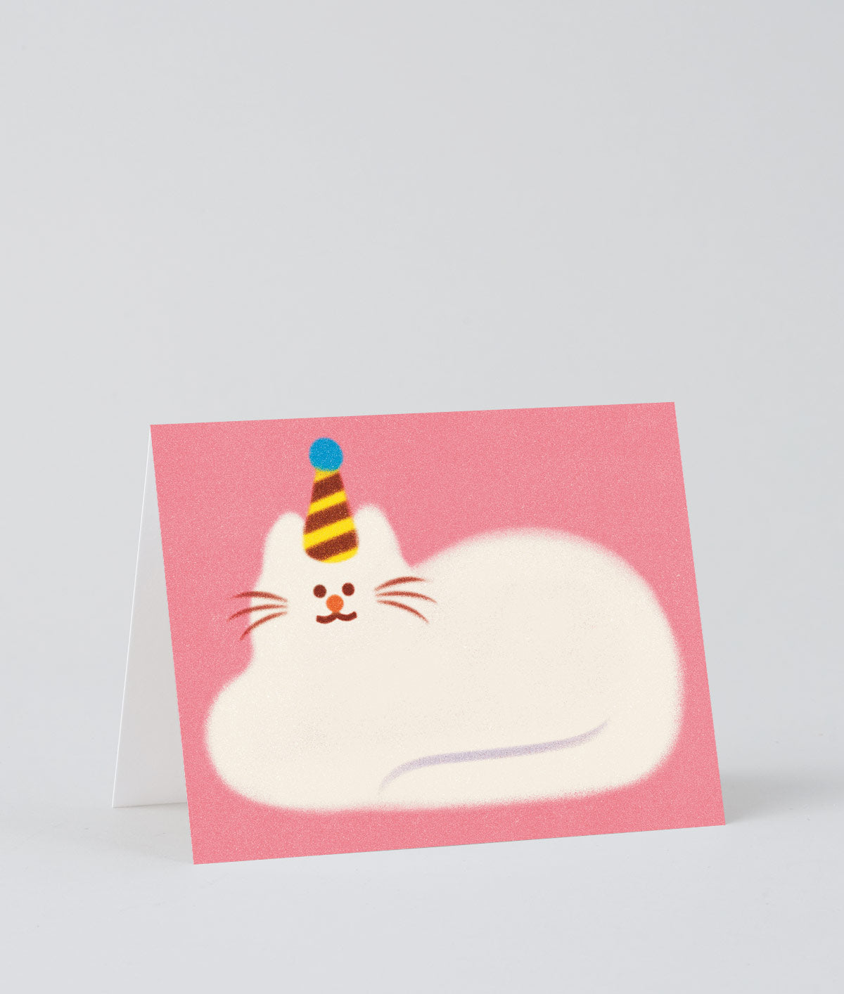 pink greetings card showing an illustration of a fluffy white cat lying down wearing a party hat