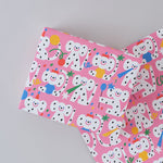 polka dot monkeys celebrating with hats and streamers cover this pink celebration birthday wrapping paper
