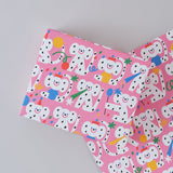 polka dot monkeys celebrating with hats and streamers cover this pink celebration birthday wrapping paper