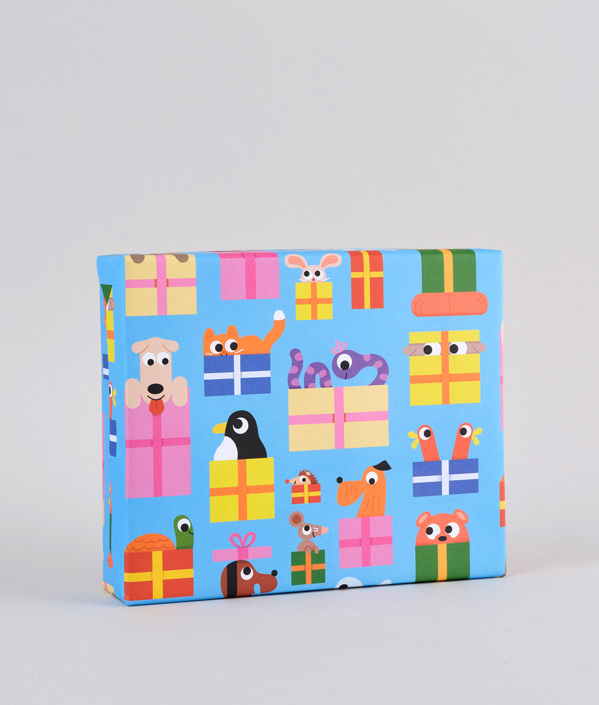 Image is a present wrapped in wrapping paper covered infun cartoon animals peeping out of presents on a blue background