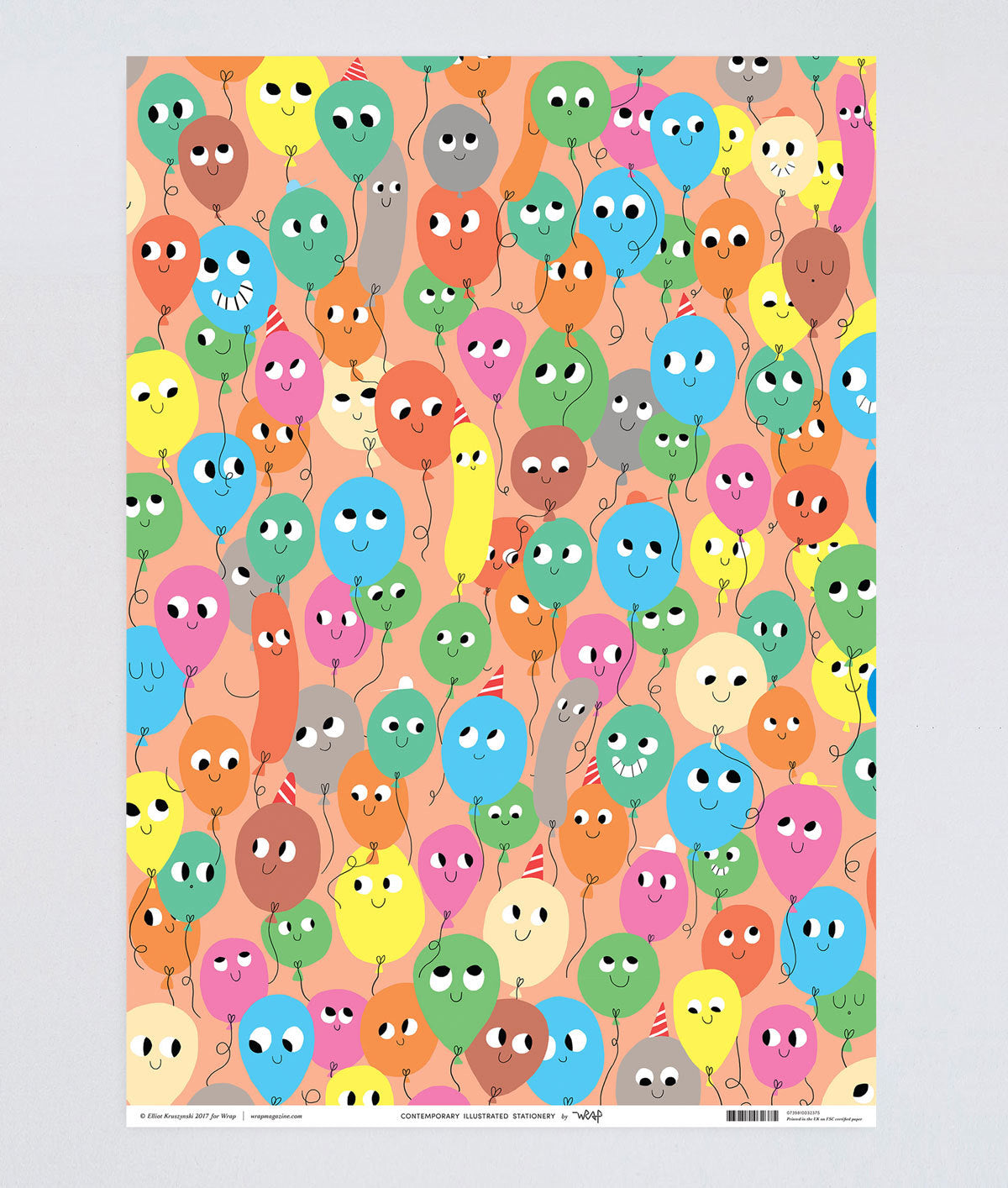 fun birthday wrapping paper smiling balloons in different colours on a peach background