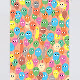 fun birthday wrapping paper smiling balloons in different colours on a peach background