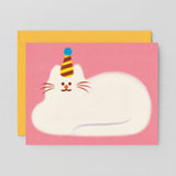 pink greetings card showing an illustration of a fluffy white cat lying down wearing a party hat