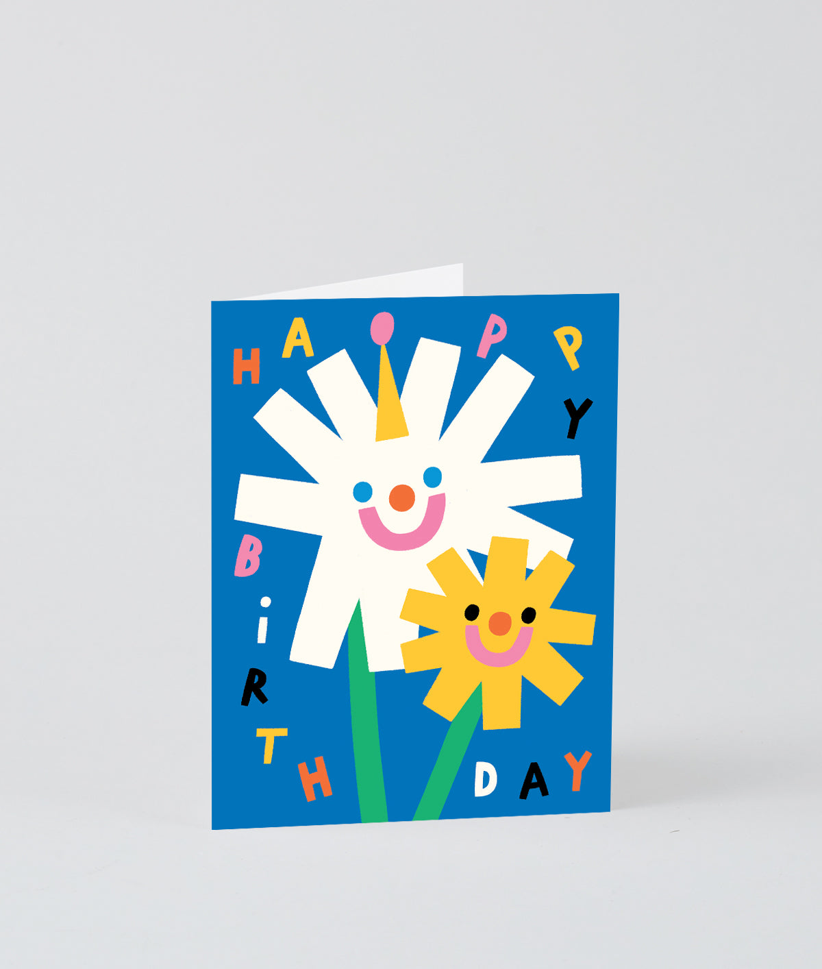 a happy smiley floral kids birthday card that says happy birthday in different colours on a blue background