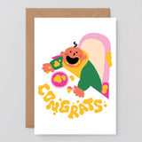 new baby card with baby covered in food and congrats spelled out in splat marks on the table
