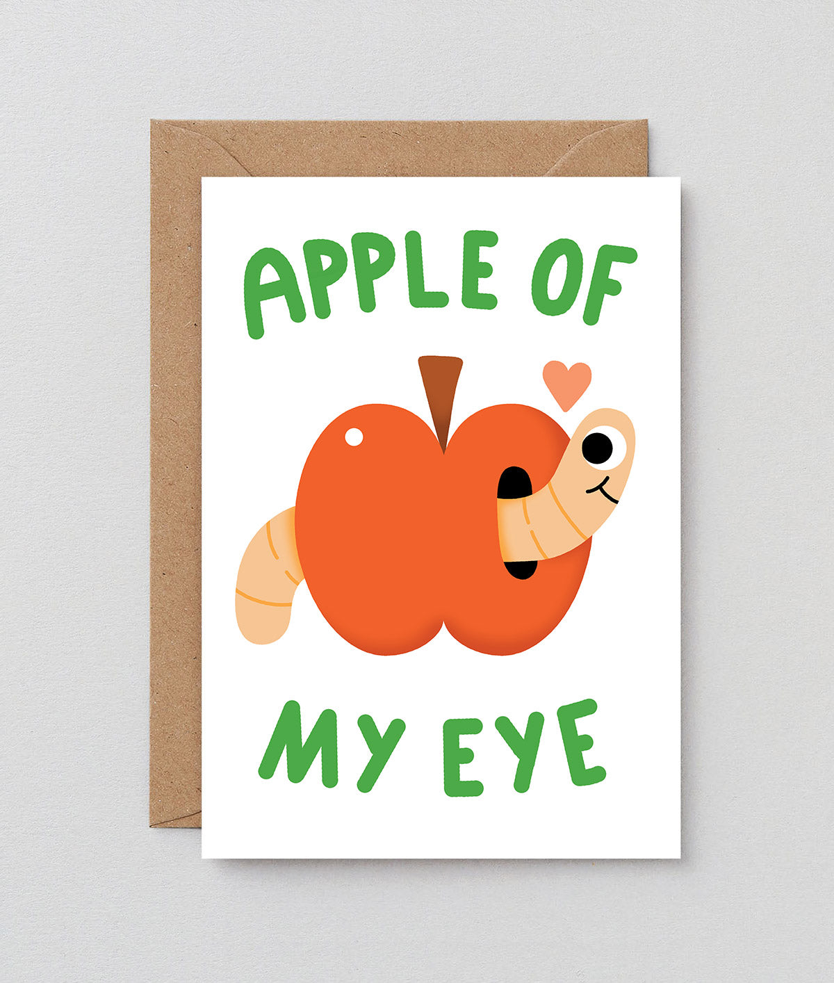 apple with a happy little worm and a small heart on a white back ground, text reads apple of my eye