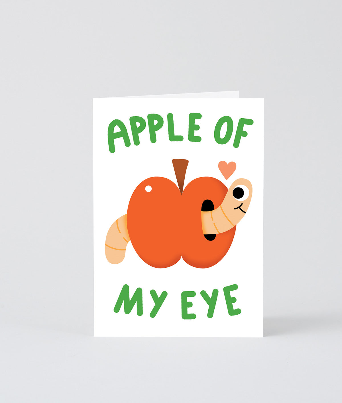 apple with a happy little worm and a small heart on a white back ground, text reads apple of my eye