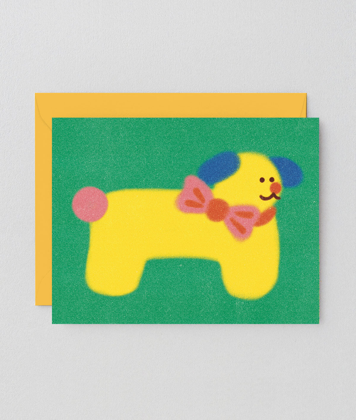 Dog birthday card with yellow dog wearing a bowtie on a green background
