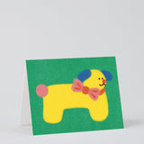 Dog birthday card with yellow dog wearing a bowtie on a green background