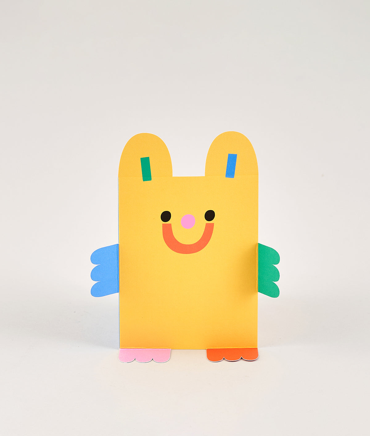 yellow die cut bear kids birthday card with green and blue arms, and red and pink feet