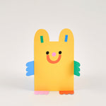yellow die cut bear kids birthday card with green and blue arms, and red and pink feet