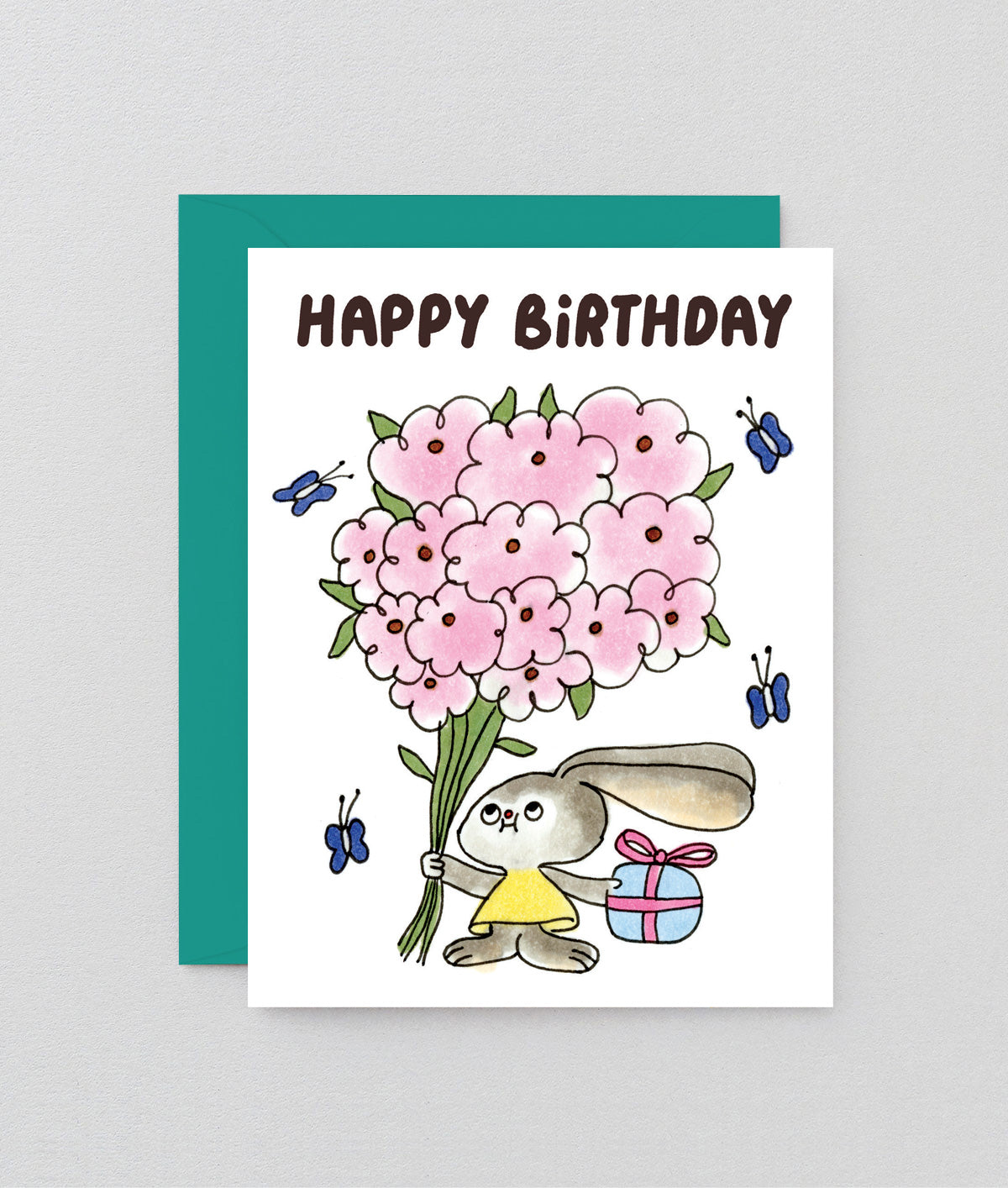 Birthday card with a cartoon bunny holding pink flowers and a gift, on a light gray background.