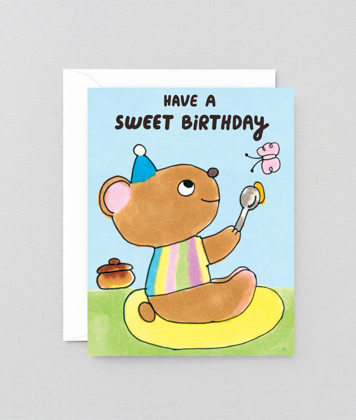 Birthday card with a cartoon bear holding a spoon and butterfly, text 'Have a sweet birthday' on a light blue background.