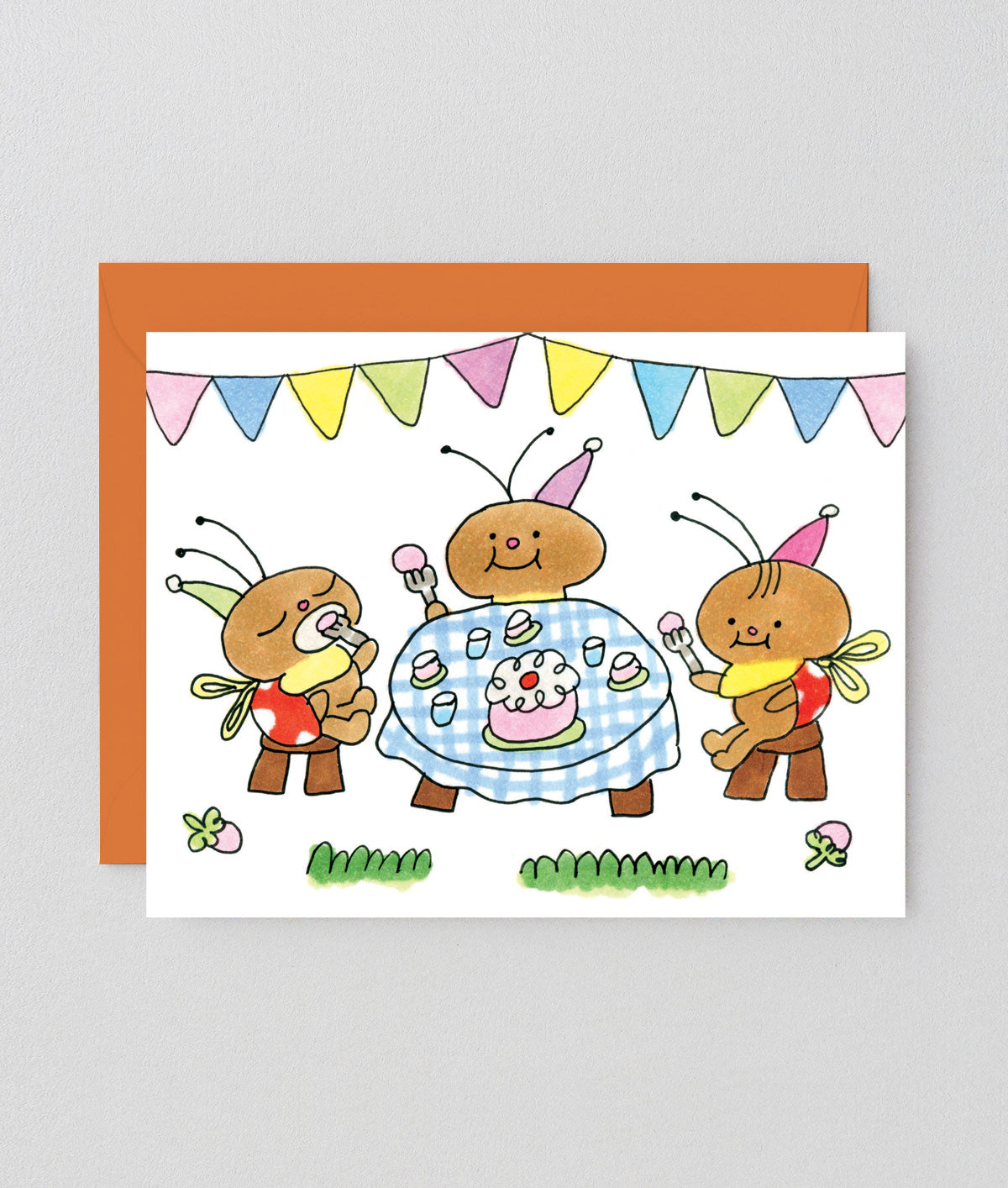 Greeting card with cartoon ants celebrating a birthday, featuring colorful flags and a cake.