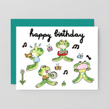 Birthday card with cartoon frogs playing instruments on a gray background