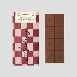Audrey's Fruit & Nut Milk Chocolate bar with checkered packaging on a light grey background