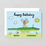 Birthday card with a green alligator and turtle illustration on a blue sky background.