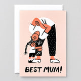 peach coloured greetings card that says Best Mum and shows a child holding on to the leg of a mum bending over smiling