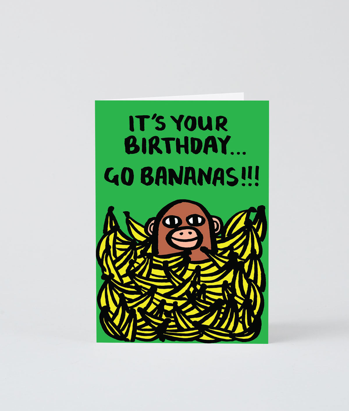 Birthday card showing a monkey in a pile of bananas saying it's your birthday...go bananas