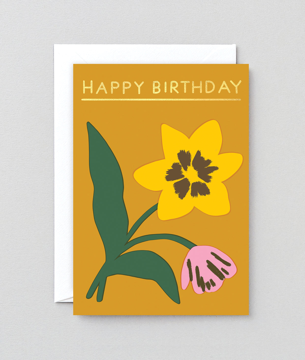 a flower birthday card on a mustard background with happy birthday written in gold