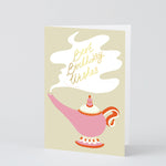 a pink genies lamp with a cloud of smoke coming out it, in which it says best birthday wishes in gold