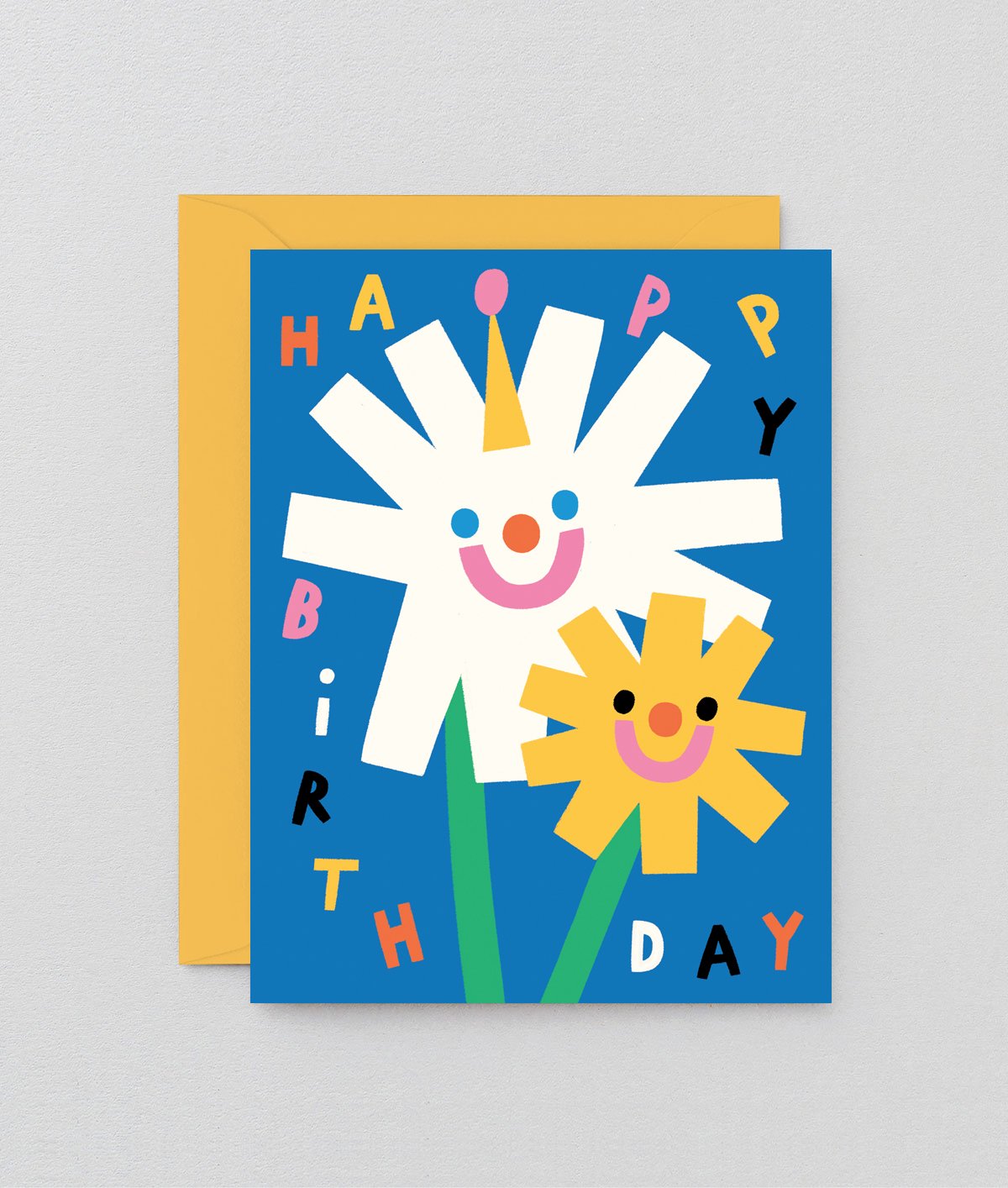 a happy smiley floral kids birthday card that says happy birthday in different colours on a blue background
