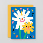 a happy smiley floral kids birthday card that says happy birthday in different colours on a blue background
